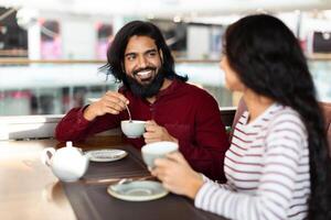 Cheerful young indian man enjoying date with his girlfriend photo