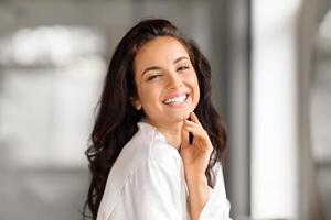 Portrait of cheerful beautiful young brunette woman in bathroom photo