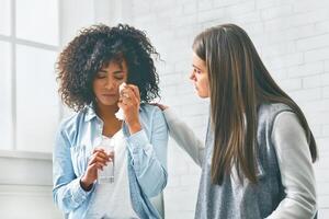 Diverse People Showing Empathy To Crying Black Woman photo