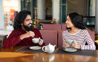 Happy young indian couple have romantic date at cafe photo