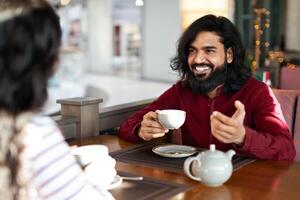 Romantic eastern couple on first date at canteen photo