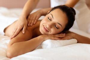 Closeup of lady client of spa receiving relaxing therapeutic massage photo