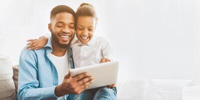 Little girl watching cartoon on tablet with father photo