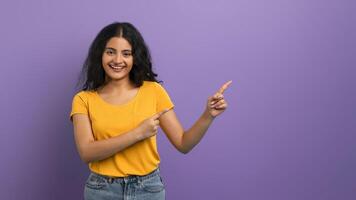 Woman in yellow pointing in two directions photo