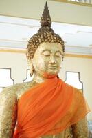 Buddha statue covered with gold leaf photo