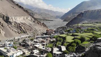 Flying over a mountain valley and mountain village in the Himalayas video