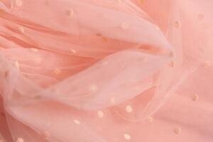 Tulle fabric texture background, textile pattern, pink polka dot on tulle, copy space photo