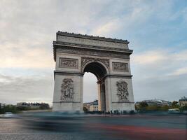 The Arc de Triomphe in Paris, France in the evening. photo