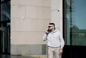 Portrait of  young man talking on phone. photo