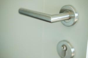 Modern metallic door handle. photo