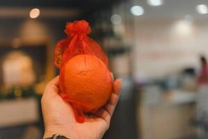 Oranges fruit in red bag for give to other during Chinese New Year festival. Believed to bring good luck and happiness. photo