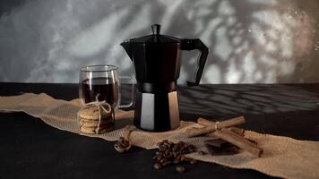 Black Geyser Coffee Maker on Textured Fabric, Low-Light Setting video