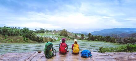 Lover woman and man Asian travel nature. Travel relax. Viewpoint Rice field of the field on the Moutain papongpieng in summer. Thailand. photo