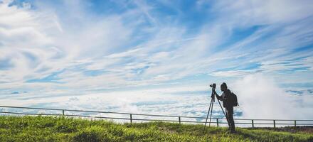 man asians travel relax in the holiday. Photograph landscape on the Moutain.Thailand photo