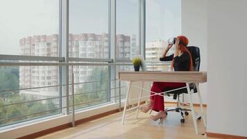 Young pretty red-haired woman wearing VR glasses. The woman is in virtual reality thanks to VR glasses. video