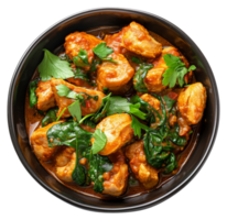 AI generated Spicy chicken tikka masala with spinach in a black bowl on transparent background - stock png. png