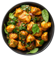 ai generato speziato pollo tikka masala con spinaci nel un' nero ciotola su trasparente sfondo - azione png. png