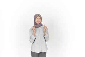 Young Asian woman wearing hijab showing love finger korean isolated on white background photo