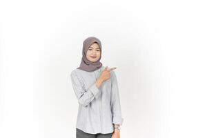 Young Asian woman wearing hijab Pointing side copy space isolated on white background photo