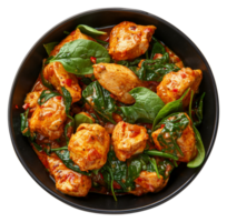 AI generated Spicy chicken tikka masala with spinach in a black bowl on transparent background - stock png. png