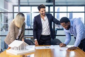 Team of architectures and businessmen discussing and brainstorming on floor plan modification for real estate investment and housing development project photo