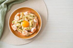 penne pasta white cream sauce with shrimps and egg photo