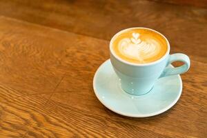 hot latte coffee cup on table photo