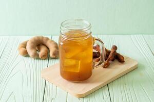 Delicious sweet drink tamarind juice and ice cube photo