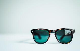 AI generated Classic Sunglasses With Gradient Lenses Sitting on a White Surface photo