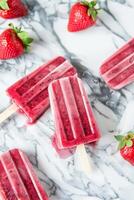 AI generated Homemade Strawberry Popsicles on a Marble Countertop During Summer photo