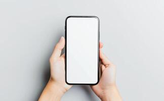 AI generated Person Holding Smartphone With Blank Screen Over Gray Background photo