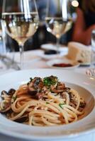 AI generated Creamy  Pasta Topped With Mushrooms and Parsley Served on a Wooden Table photo