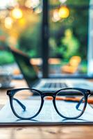 AI generated Close-Up View of Eyeglasses With Blurred Laptop and Smartphone in Background photo