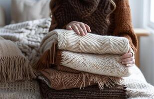 AI generated Cozy Hands Resting on a Pile of Warm Knitted Sweaters photo