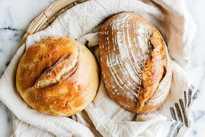 AI generated Freshly Baked Artisan Bread Loaves With Golden Crusts and Flour Dusting photo