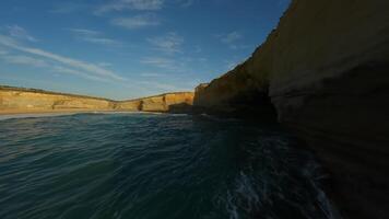 Rocks and a sandy cliff by the ocean in Australia video