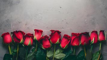 AI generated Red roses layout on gray desktop background, top view photo