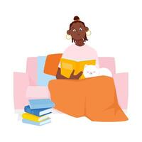 Dark-skinned young woman sitting with a cat on the sofa and reading a book vector