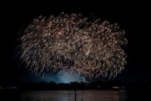 fireworks on the river in the dark sky photo