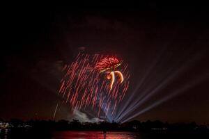 fireworks on the river in the dark sky photo