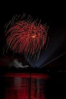 fireworks on the river in the dark sky photo