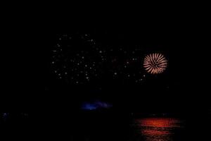 fireworks on the river in the dark sky photo