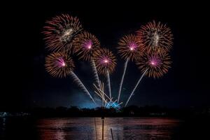 fireworks on the river in the dark sky photo