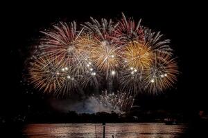 fireworks on the river in the dark sky photo