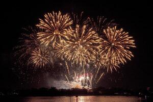 fireworks on the river in the dark sky photo