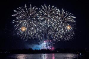 fireworks on the river in the dark sky photo