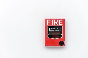 Fire alarm switch box on white wall for warning with copy space photo