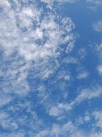 Beautiful white clouds on deep blue sky background. Large bright soft fluffy clouds are cover the entire blue sky. Skyscape on Lombok Island, Indonesia photo