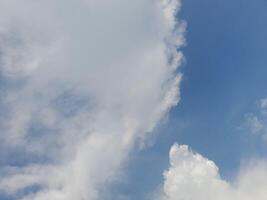 Beautiful white clouds on deep blue sky background. Large bright soft fluffy clouds are cover the entire blue sky. Skyscape on Lombok Island, Indonesia photo