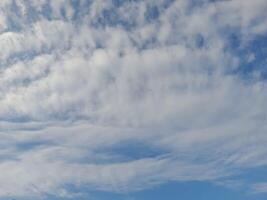 The white clouds on the blue sky are perfect for the background. Skyscape on Lombok Island, Indonesia photo